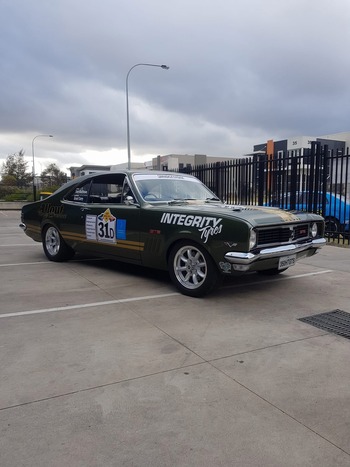  Classic green Holden Torana race car with Integrity Tyres branding parked outside workshop