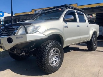  Lifted Toyota Hilux with heavy-duty bull bar and mud-terrain tyres